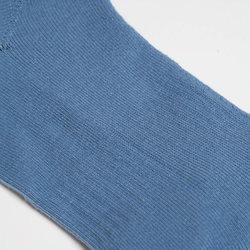 Close-up of a blue sock on a light gray background