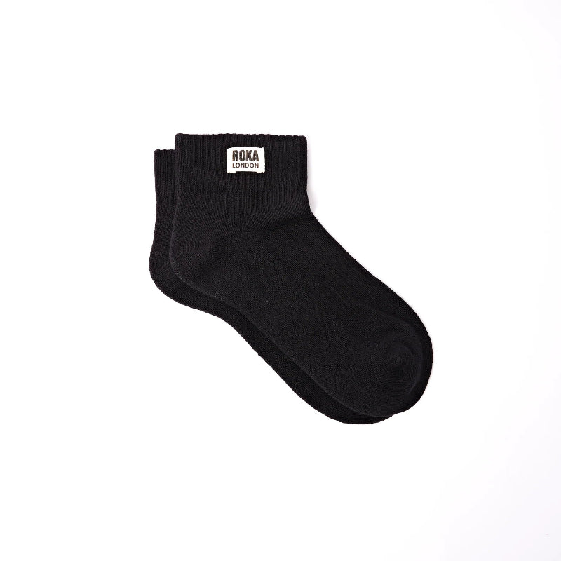 Black sock with a brand label on a white background