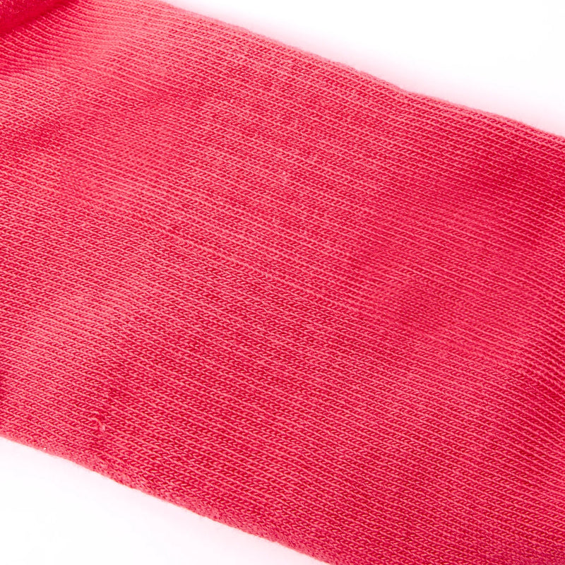 Close-up of a red sock with visible texture on a white background