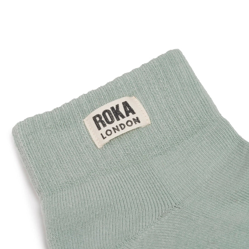 Light blue sock with 'ROKA LONDON' label on a white background