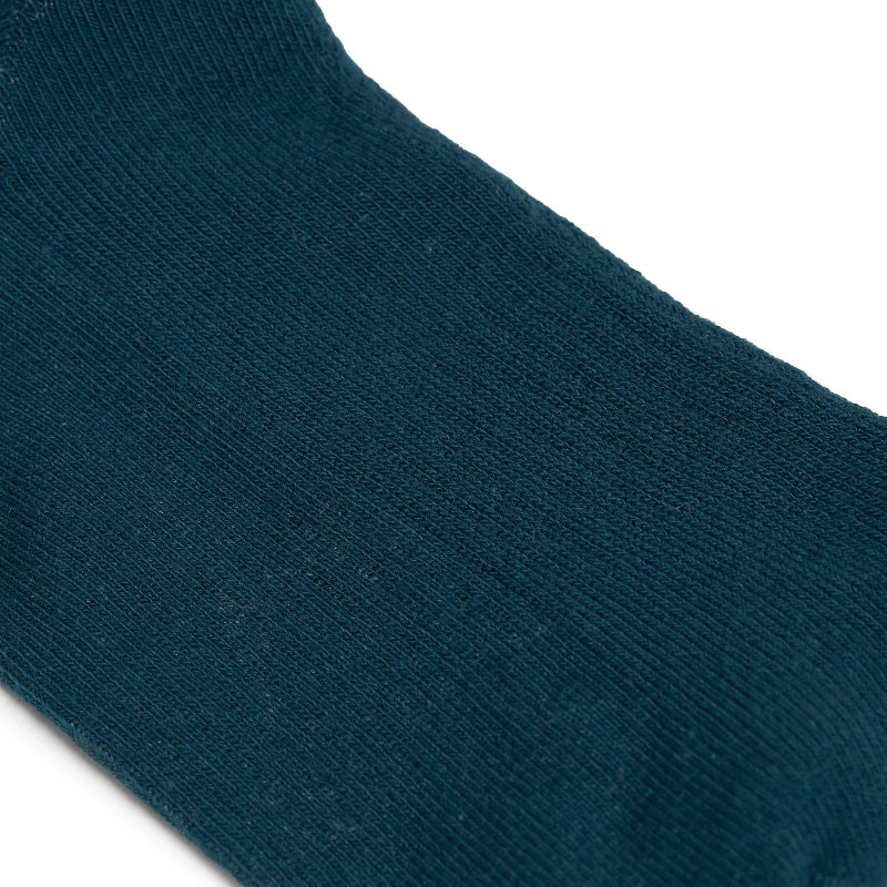 Close-up of a teal sock on a white background