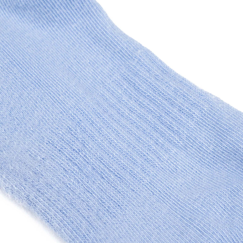 Close-up of a light blue sock on a white background