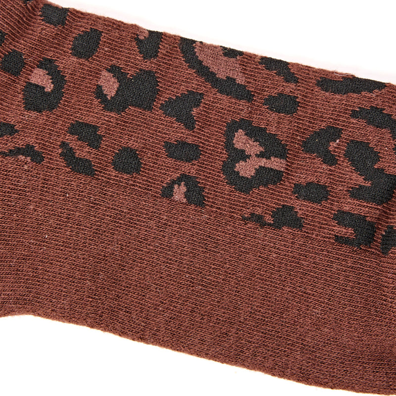Brown sock with black leopard print pattern on a white background