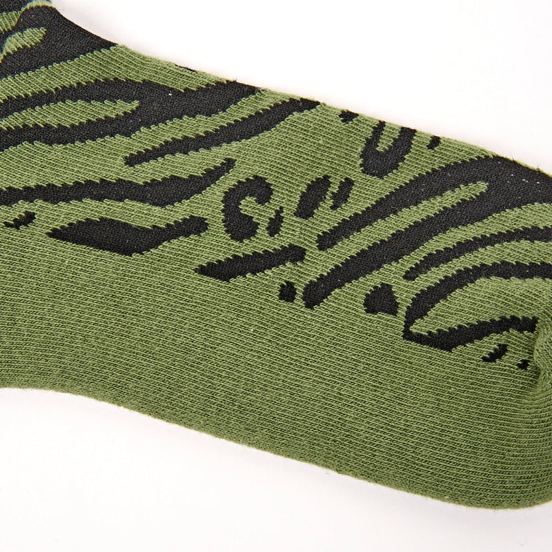 Green sock with black tiger design on a white background