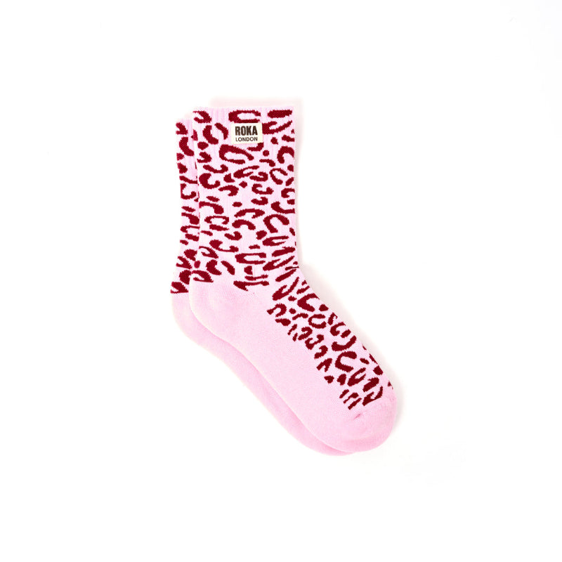 Pink sock with pink leopard print pattern on a white background