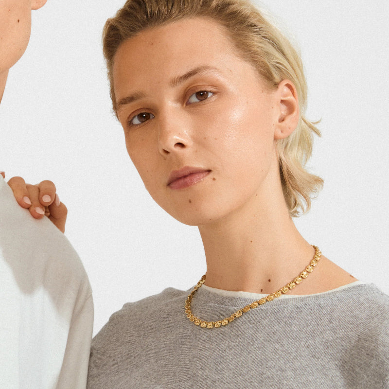 Two people wearing Pilgrim Sense Necklace Gold-platedagainst a white background