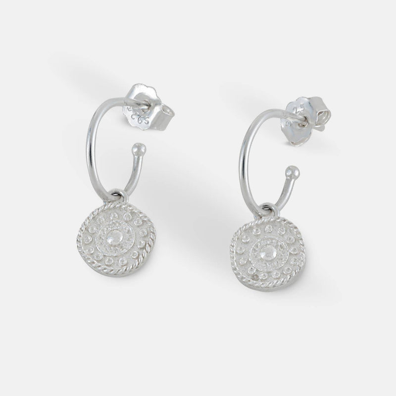 Pair of silver earrings on a white background
