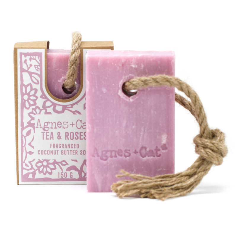 Pink soap bar with rope and packaging labeled 'Agnes + Cat' on a white background