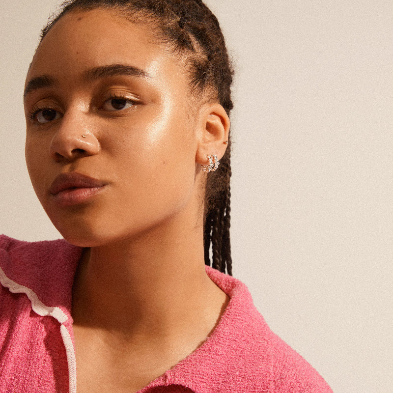 Woman wearing a pink jacket with a neutral background