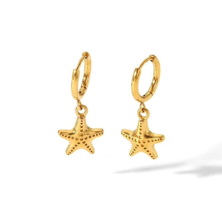 Gold starfish earrings on a white background