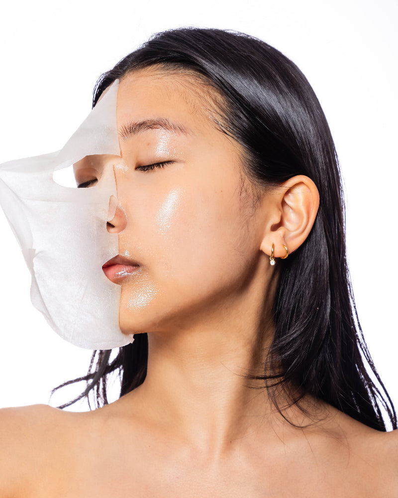 Woman with a white face mask on her nose against a white background