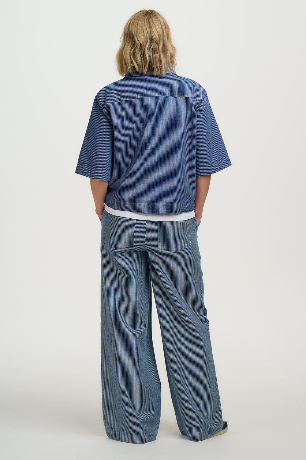 Person wearing a Sugarhill Amity Jacket-Blue Stripe Denim with wide-leg pants on a white background