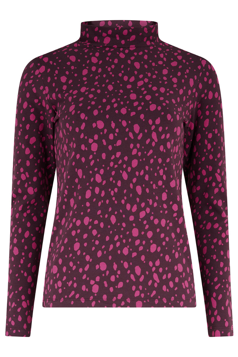 Purple long-sleeve top with pink polka dot pattern on a white background