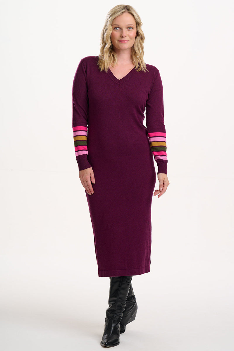 Woman wearing Sugarhill Dania Knit Midi Dress a purple dress with colourful stripes on sleeves against a white background