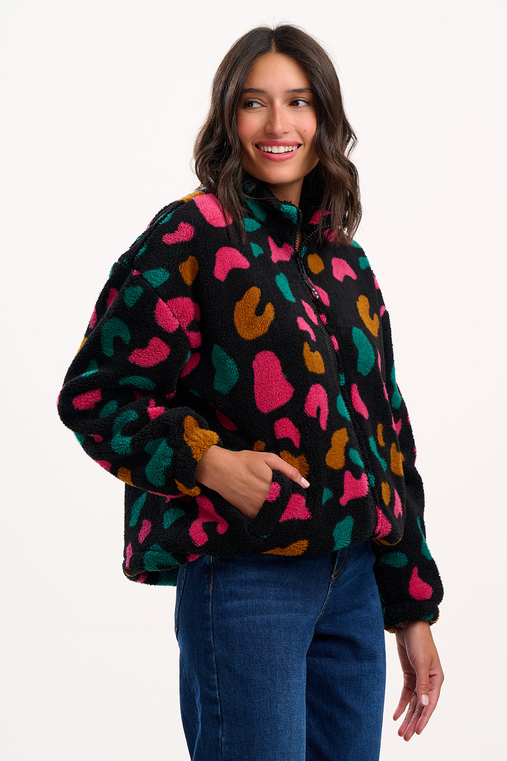 Woman wearing a colorful patterned sweater on a white background