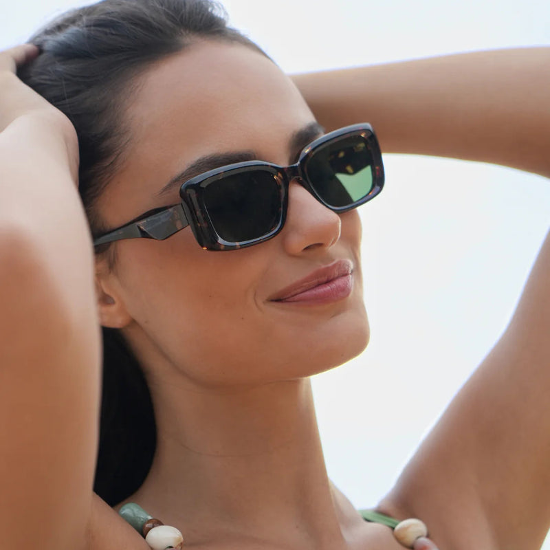 Woman wearing sunglasses with a blurred background