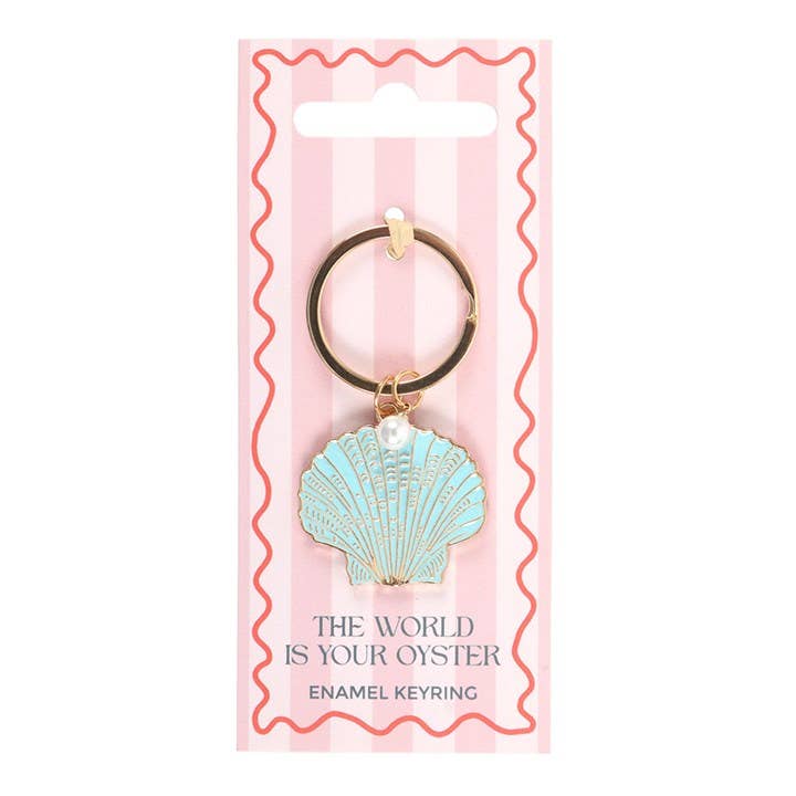 Enamel keyring with shell design on a pink packaging background