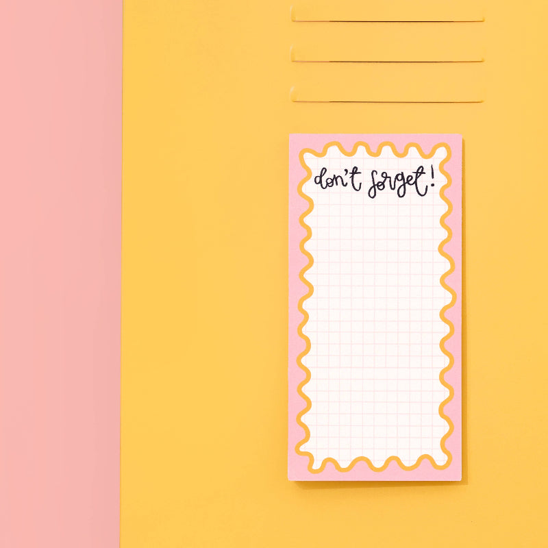 Notepad with 'don't forget!' text on a pink and yellow background