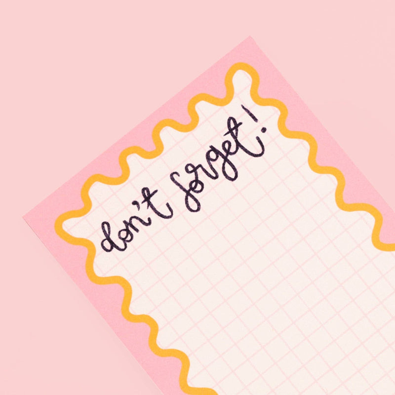 Note with 'don't forget!' text on a pink background