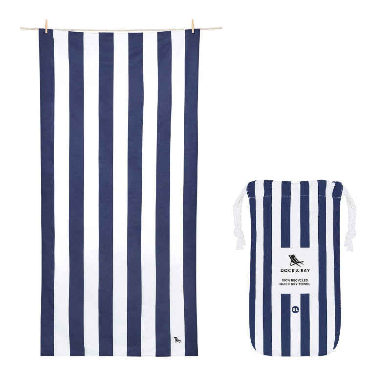 Navy and white striped towel and pouch with 'Dock & Bay' branding on a white background
