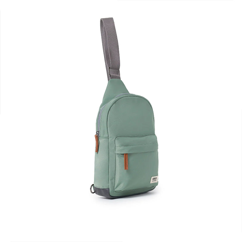 Green sling bag with gray strap on a white background