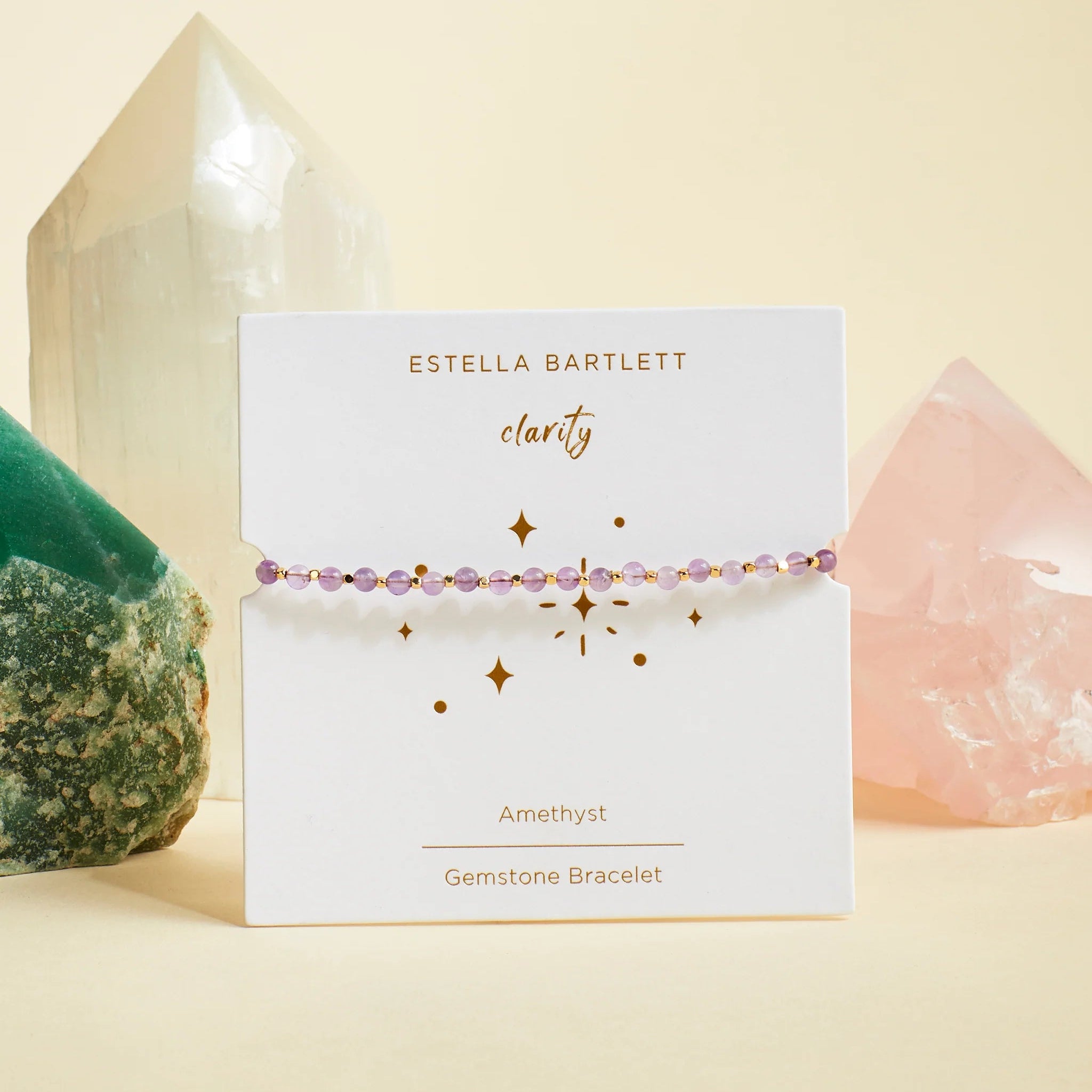 Estella Bartlett gemstone bracelet on a card with crystals in the background