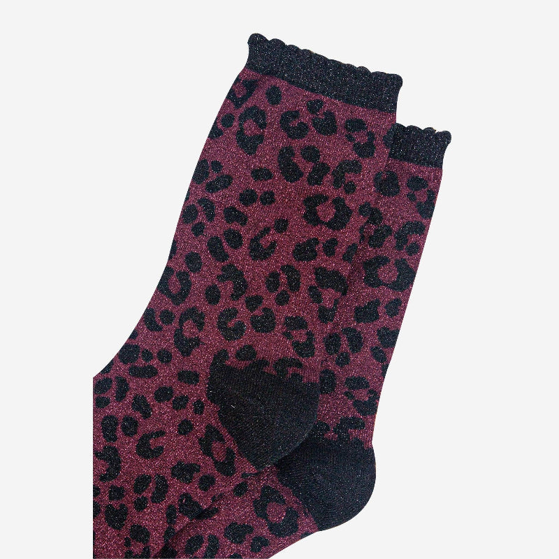Purple sock with black leopard print pattern on a white background