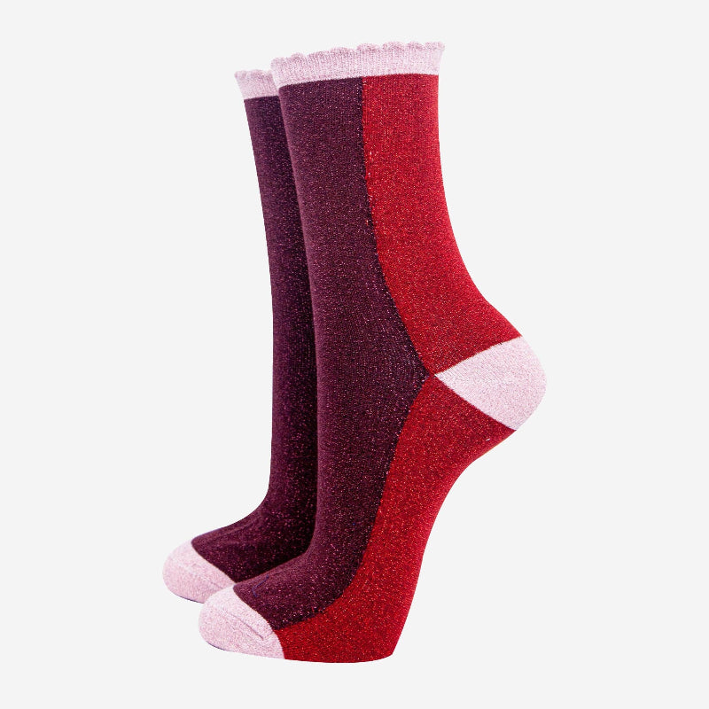 Two pairs of socks, one red and one purple, on a white background