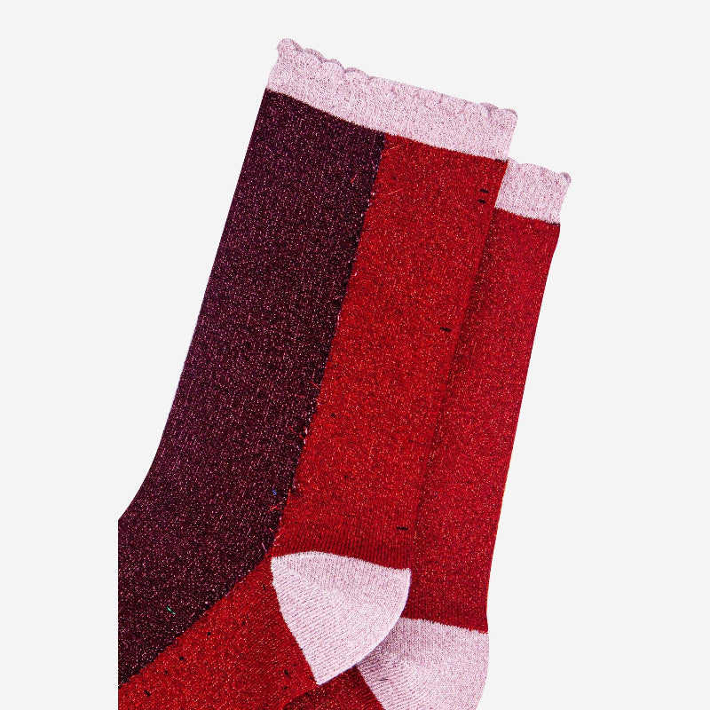Red and purple sock with white trim on a light gray background