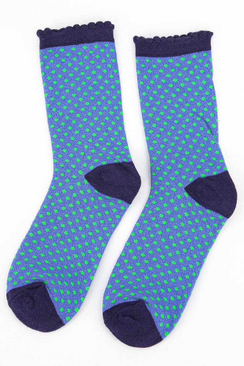 Pair of socks with blue and green pattern on a white background