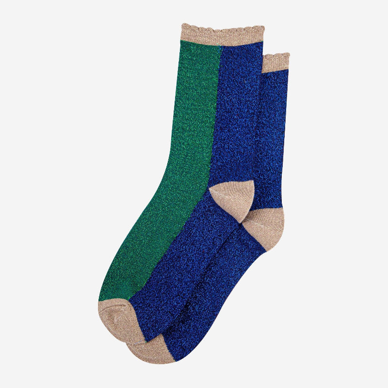 Pair of green and blue socks with beige accents on a white background