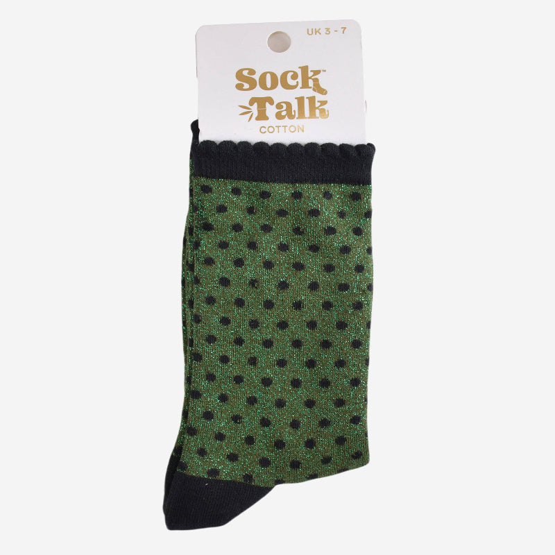 Green polka dot sock with black accents on a white background, featuring 'Sock Talk' branding.