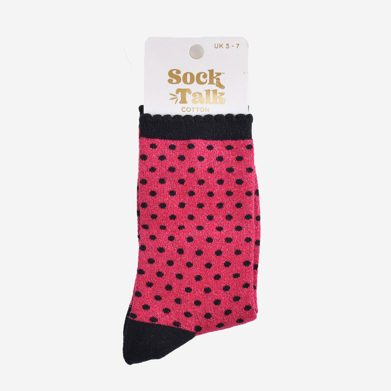 Pink socks with black polka dots on a white background