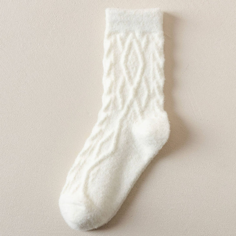 White cable knit sock on a beige background
