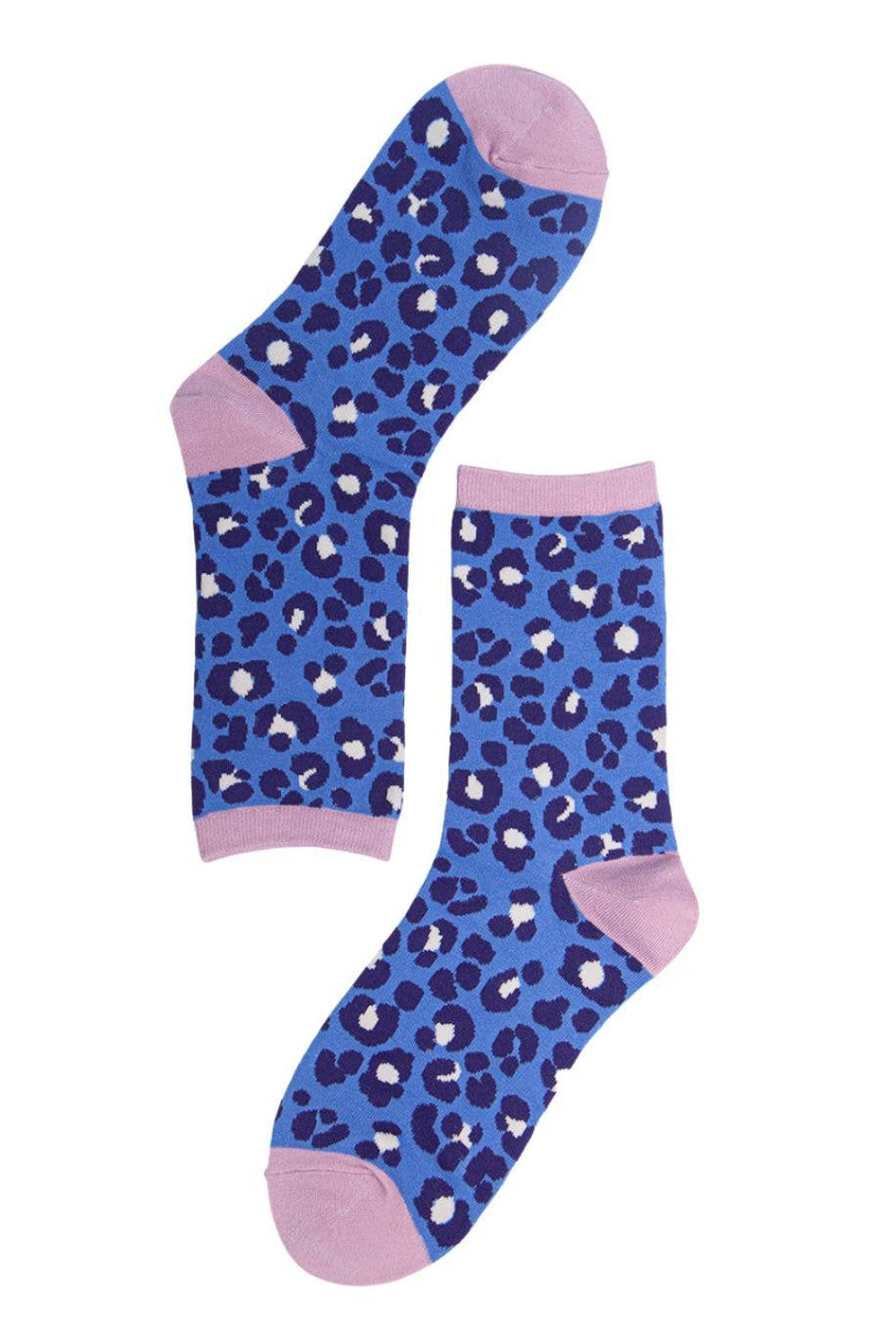 Blue socks with white leopard print and pink toes and cuffs on a white background