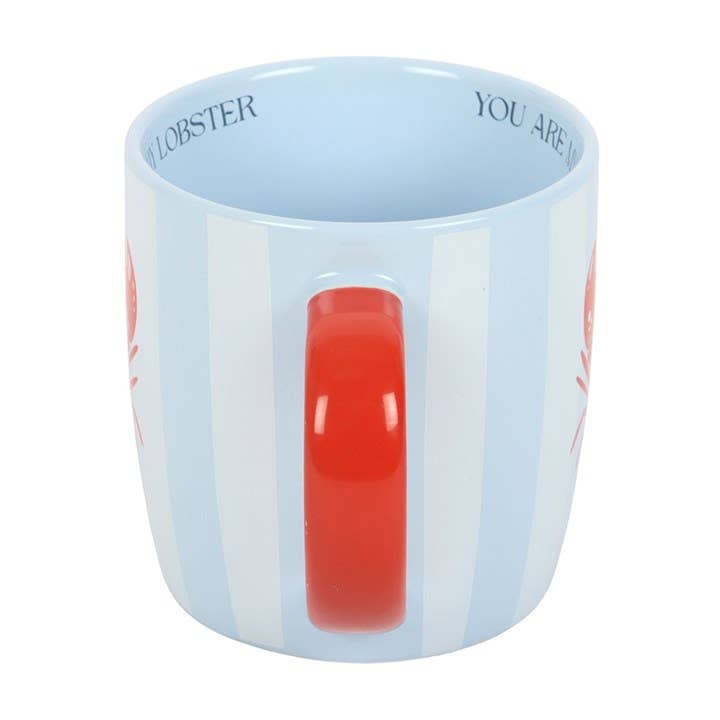 Mug with a red handle and text on a light blue background