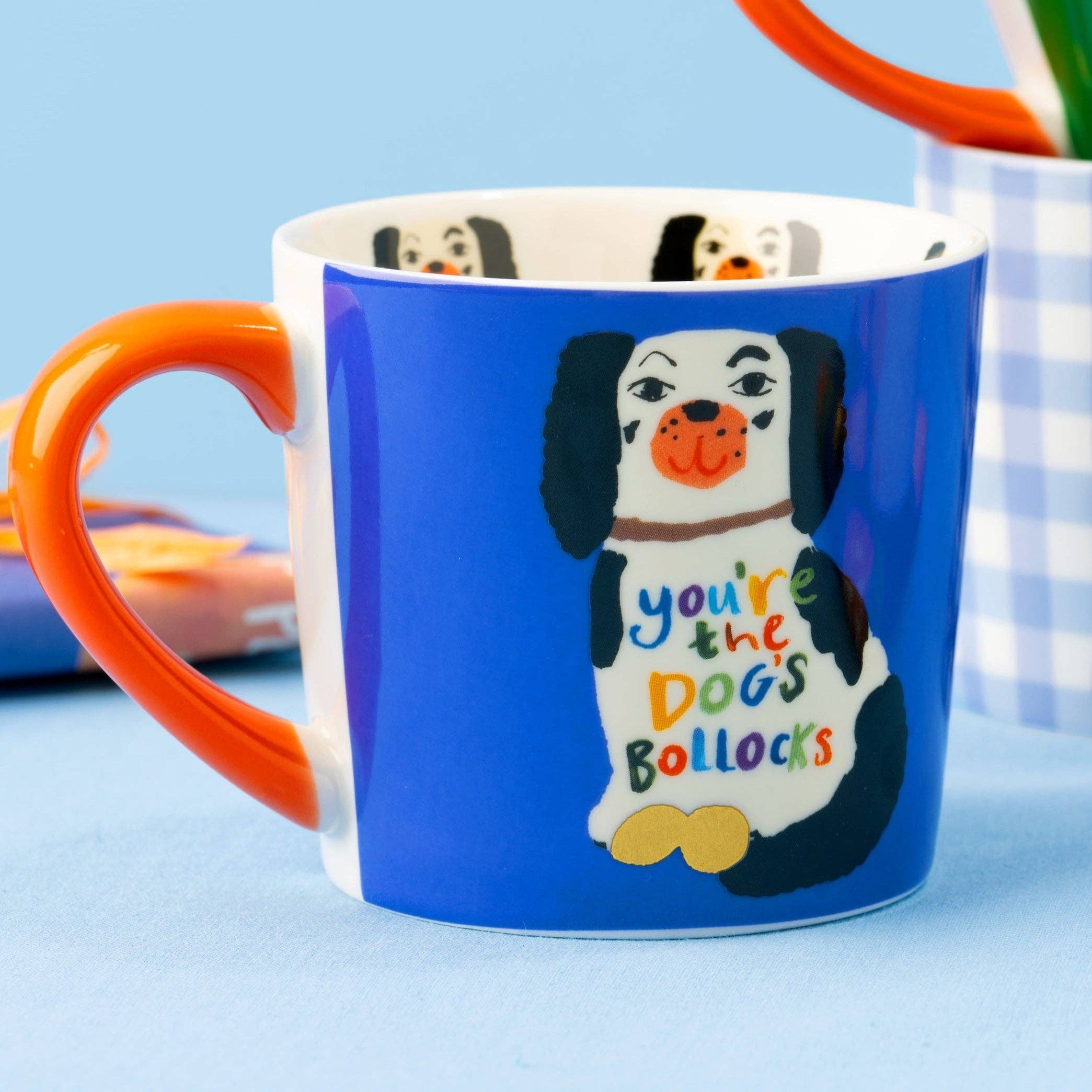 Blue mug with a dog illustration and text on a light blue background