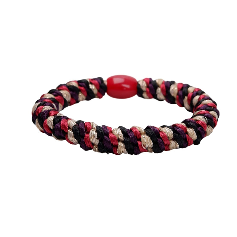 Multicolored braided bracelet with a red bead on a white background