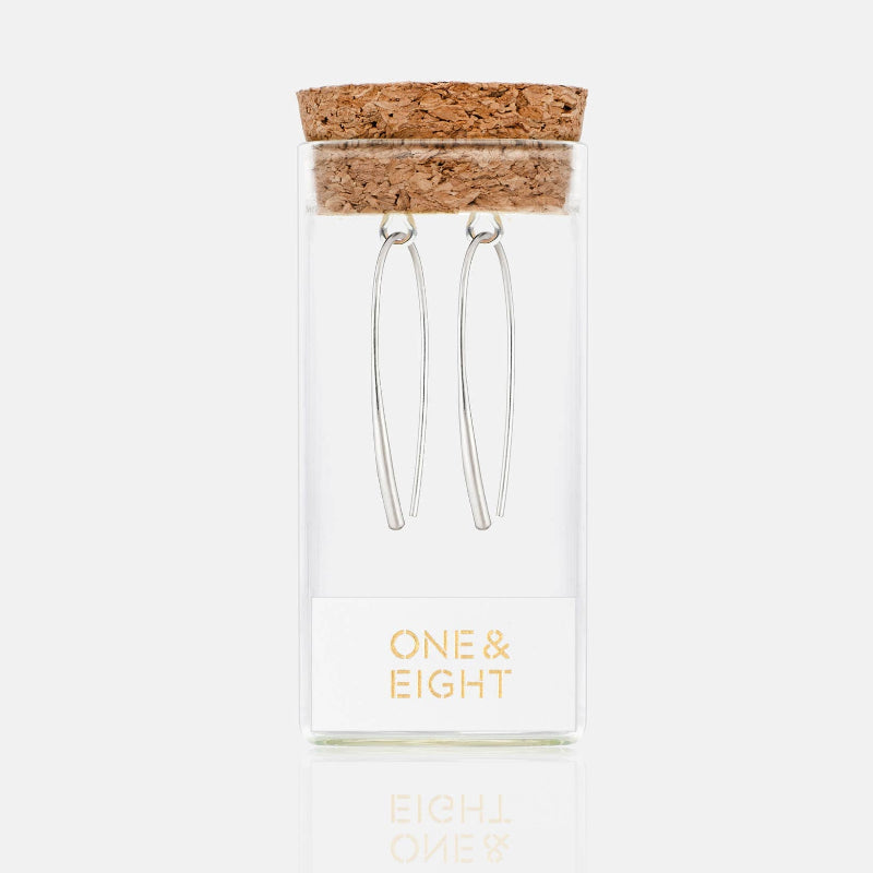 Hair pins with cork lid in a clear box labeled 'One & Eight' on a white background