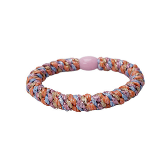 Multicolored braided bracelet with a pink bead on a white background