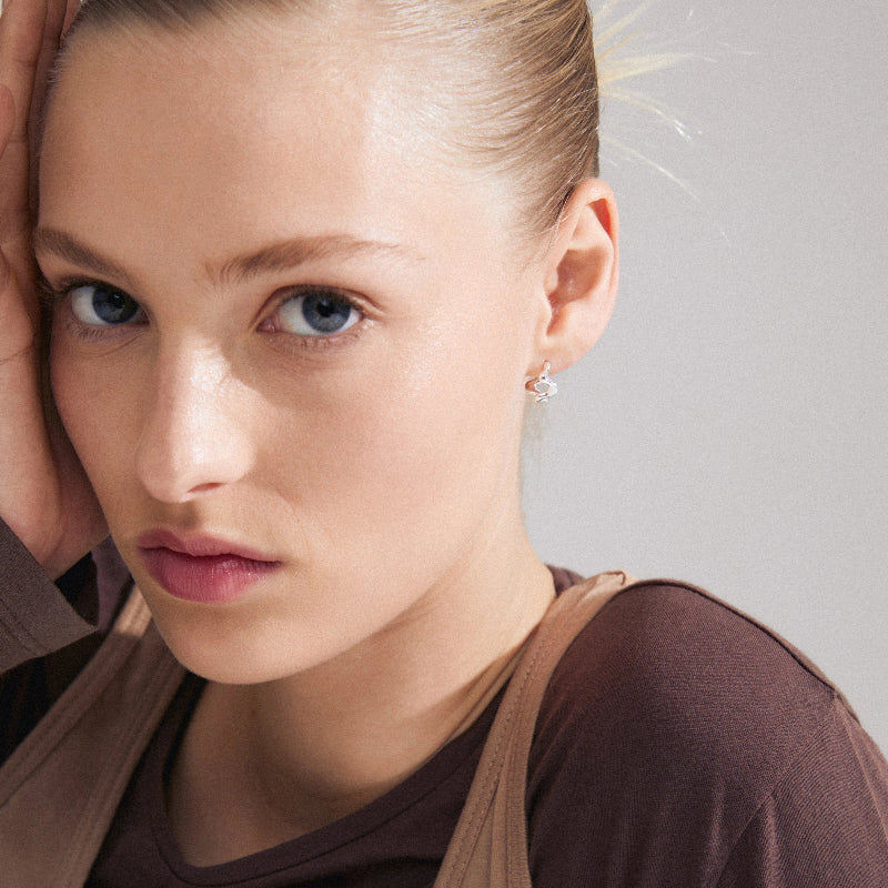 Close-up of a woman wearing Pilgrim Penelope Earrings Silver-plated