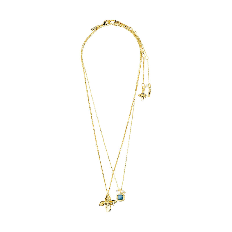 A delicate gold double-layer necklace featuring a small gold flower charm and a small round charm with a light blue stone, displayed on a clean white background.