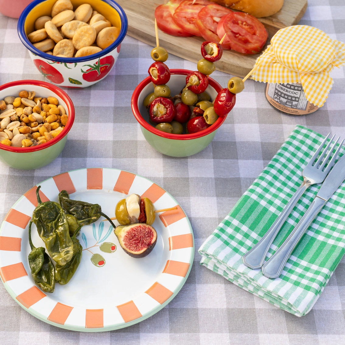 Bon Appetit Enamel Plate Olive - 25cm on a picnic blanket