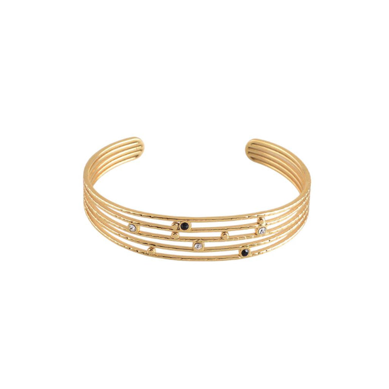 Gold bracelet with multiple bands and small gemstones on a white background