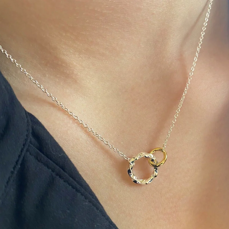 twisted silver ring interlocking with gold ring necklace