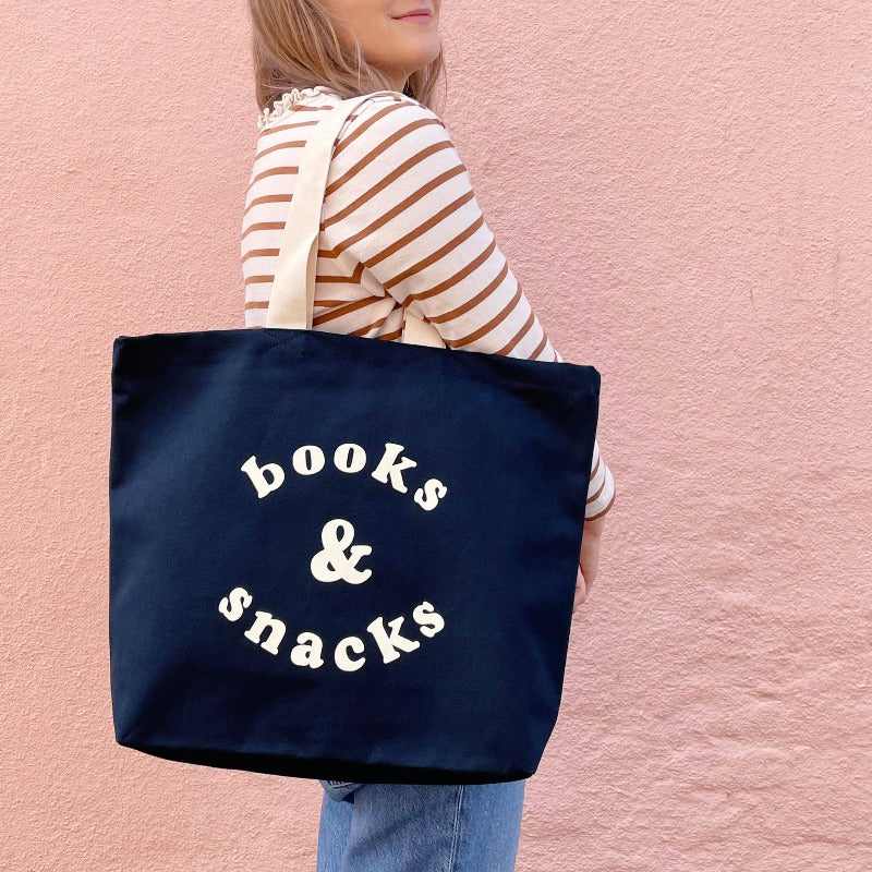 tote bag navy blue with 'books & snacks' printed in cream