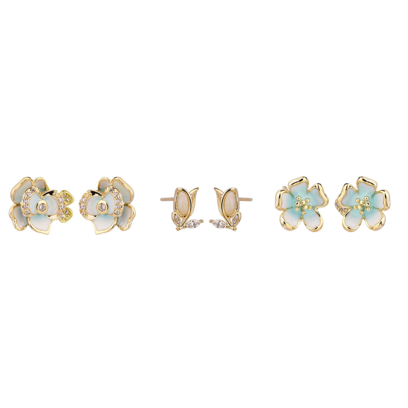 Set of floral earrings with gold and light blue colors on a white background