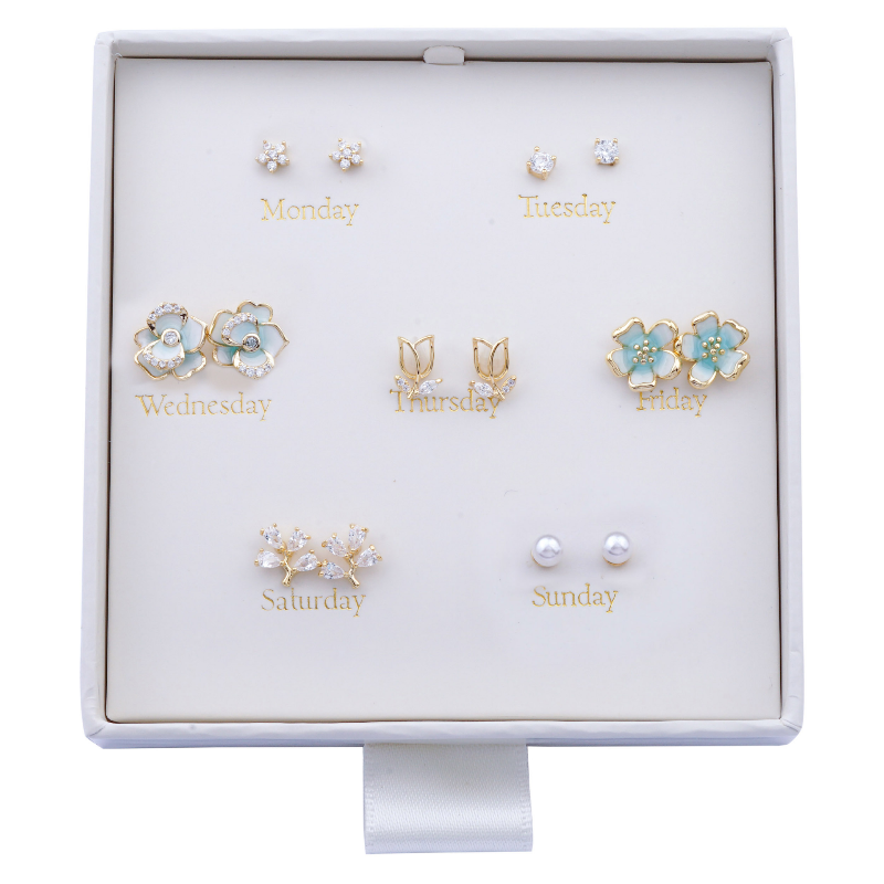 Set of earrings for each day of the week in a display box