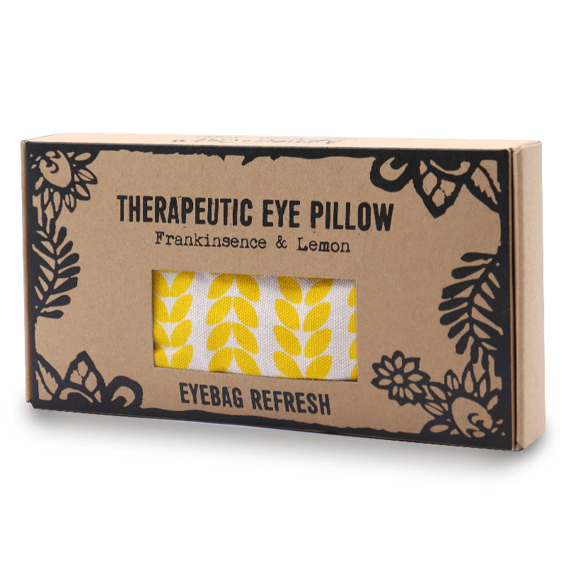 Boxed therapeutic eye pillow with yellow pattern on a white background