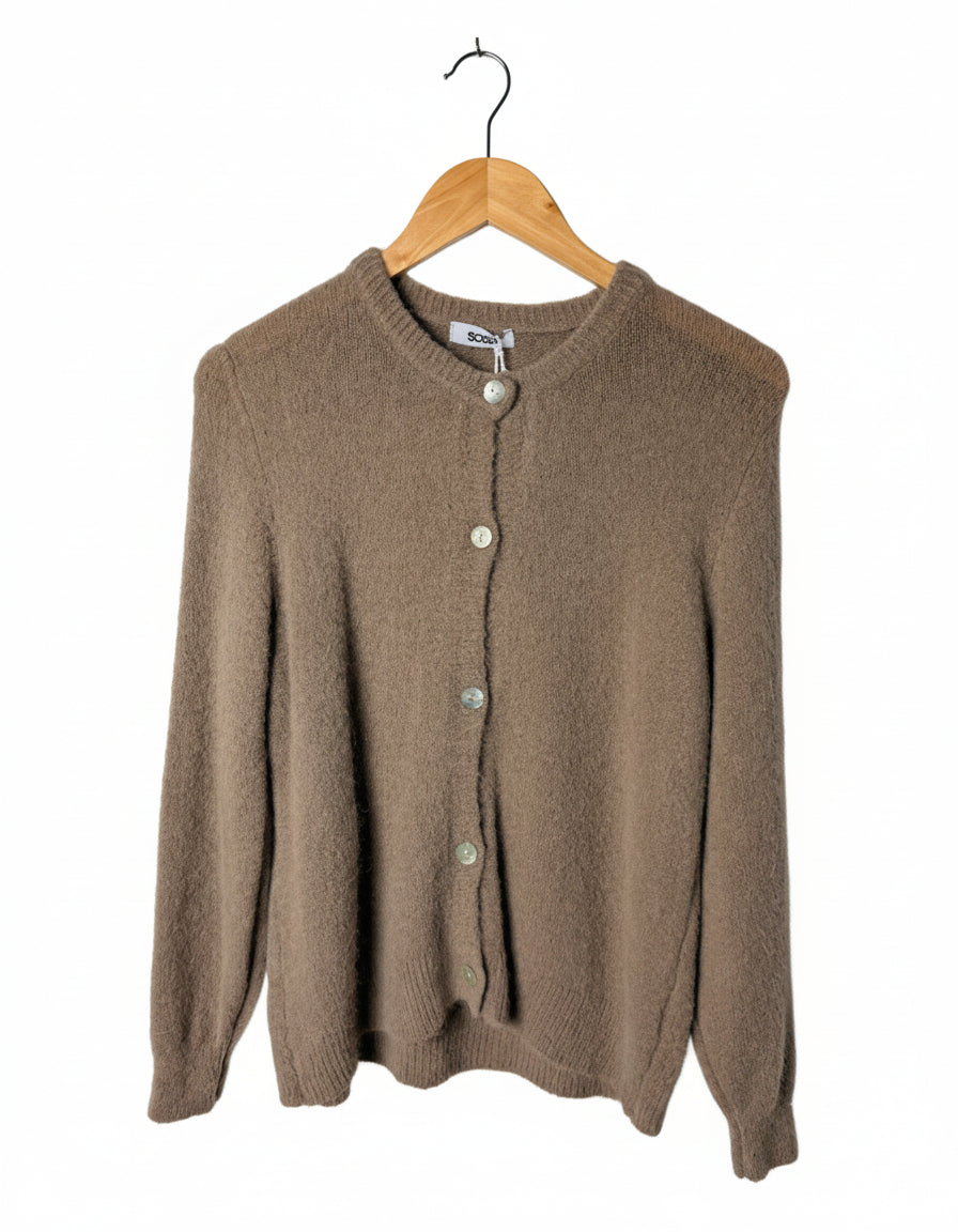 Brown cardigan on a wooden hanger against a white background